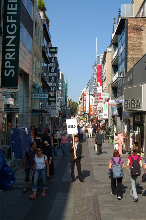 geld — the Cologne shopping street with the word 'geld' (money) overlaid