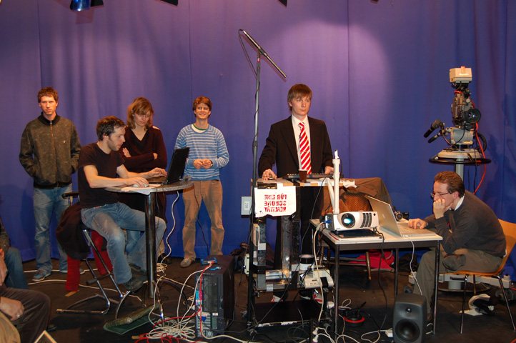 The team at the command desk with the 'I buy everything' sign